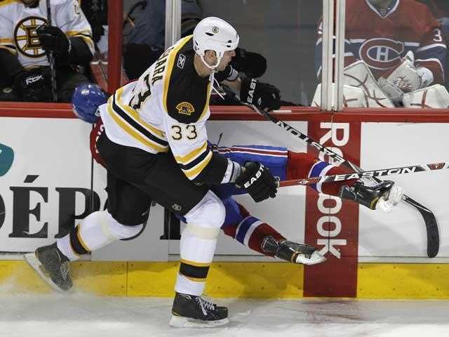Boston Bruins defenseman Steven Kampfer (44) plays the puck