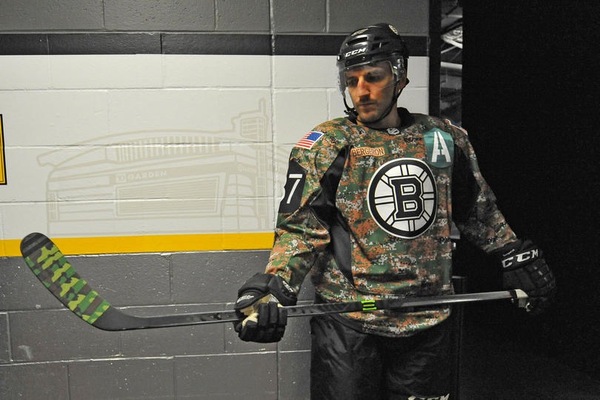 Brad Marchand of the Boston Bruins wears a camo jersey for